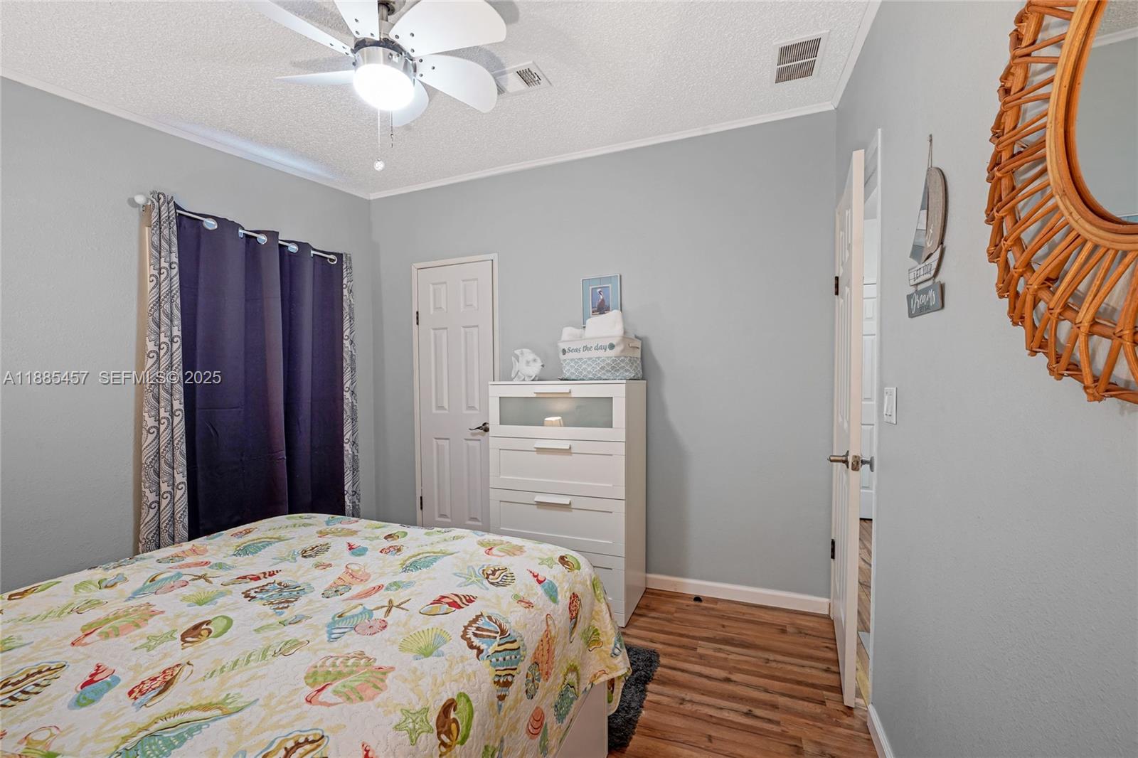 945 Plantation Road, Unit 945 Key Largo, FL 33037 - Photo 33 of 66 a bedroom with a bed and wooden floor