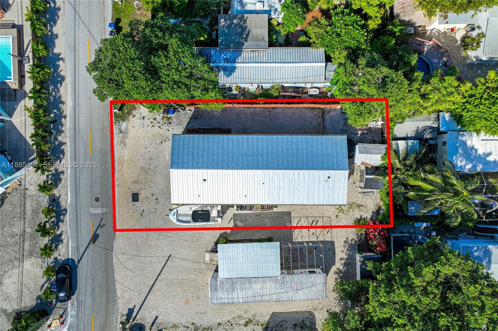 945 Plantation Road, Unit 945 Key Largo, FL 33037 - Photo 45 of 66 an aerial view of a house with a yard and a large tree