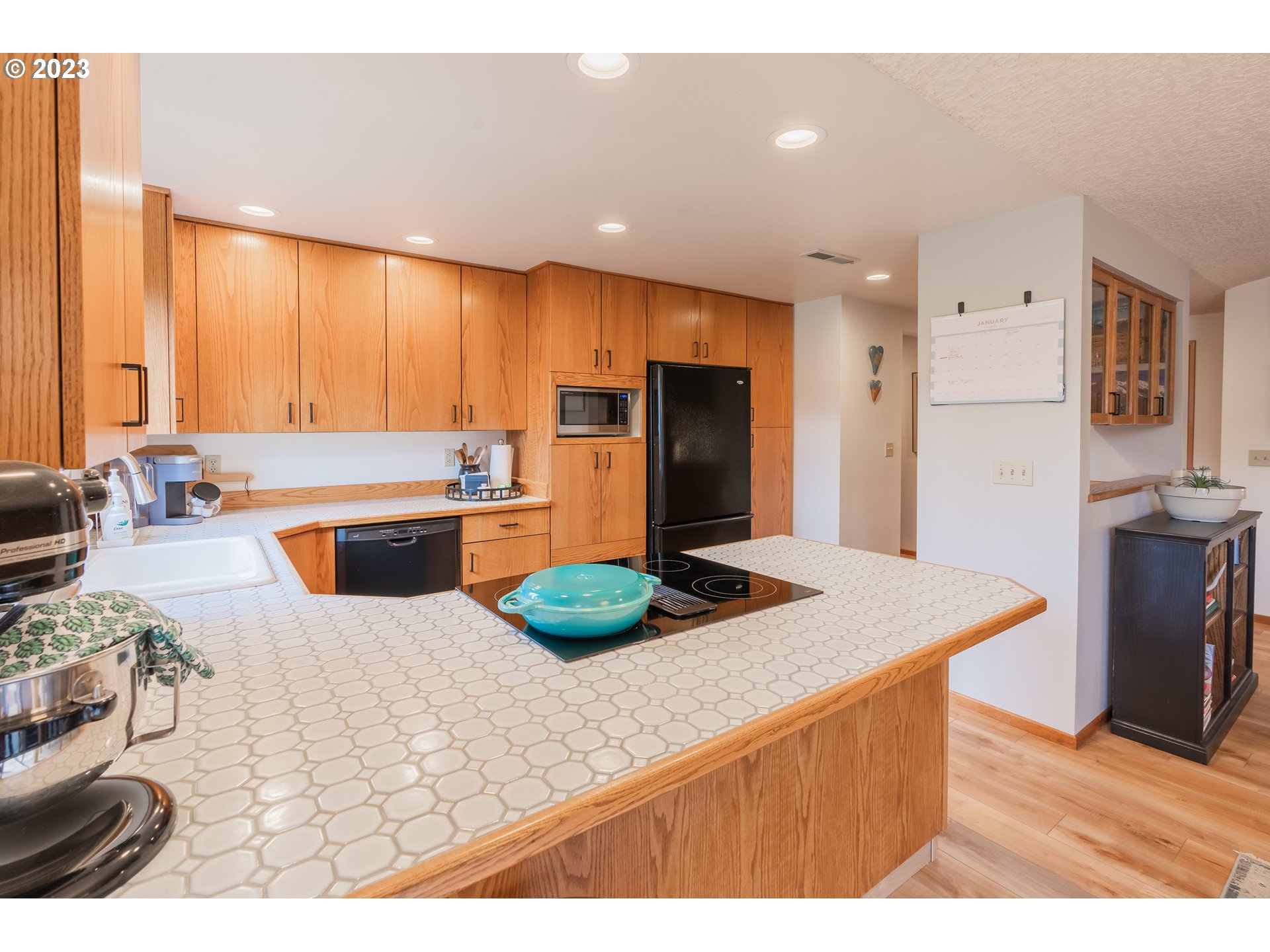 3300 Northeast 164th Street, Unit D1 Ridgefield, WA 98642 - Photo 12 of 27 a kitchen with stainless steel appliances kitchen island granite countertop a refrigerator a sink a stove a dining table and chairs
