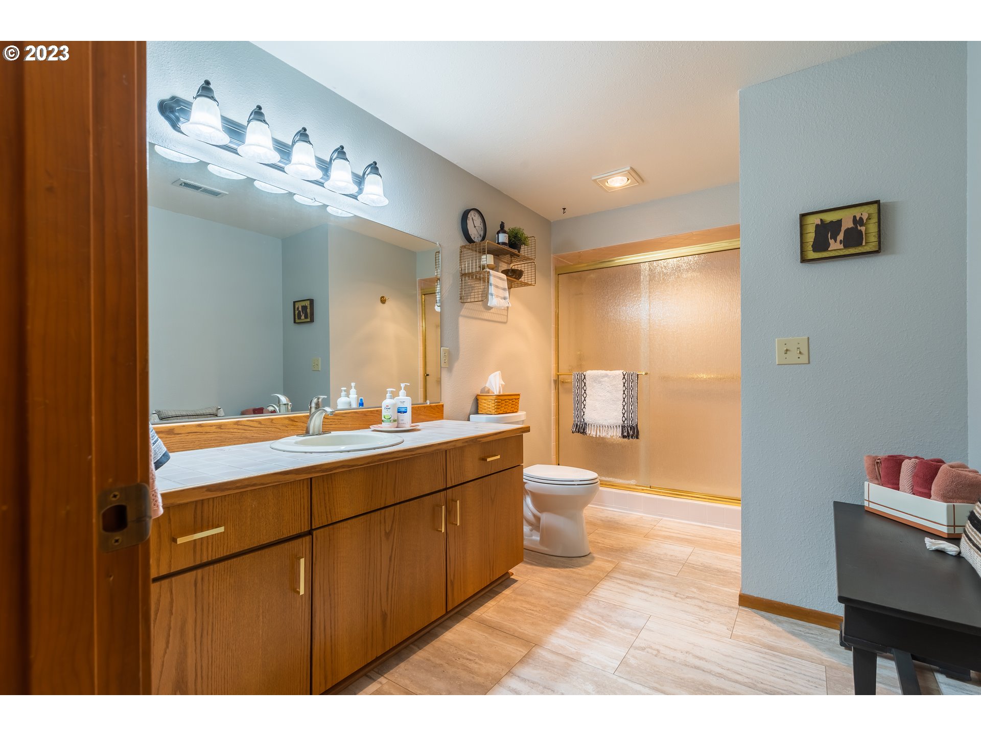 3300 Northeast 164th Street, Unit D1 Ridgefield, WA 98642 - Photo 19 of 27 a bathroom with a sink mirror and a shower