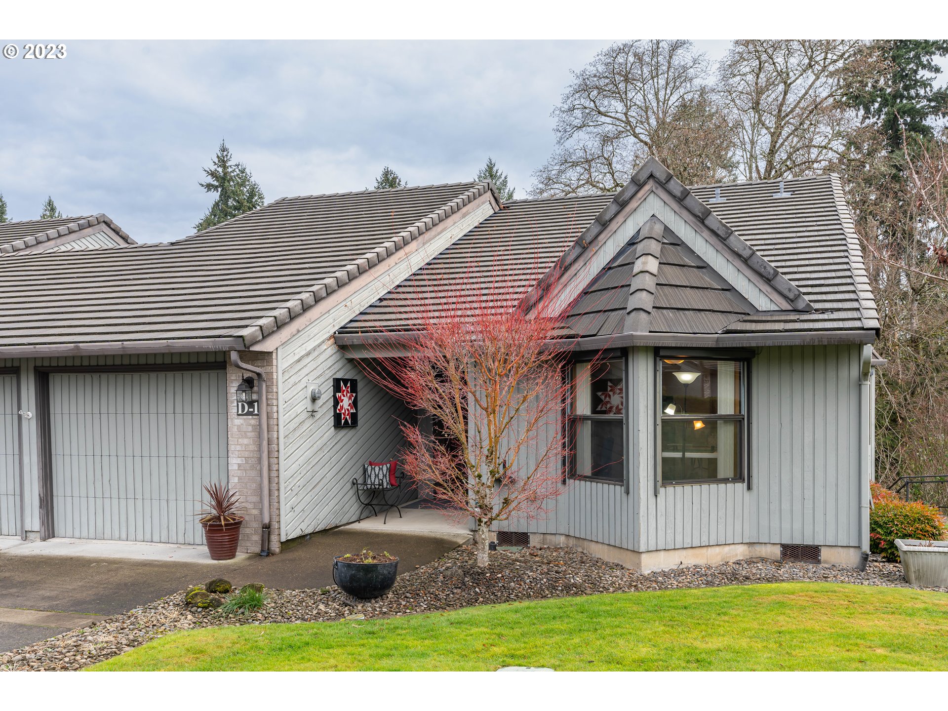 3300 Northeast 164th Street, Unit D1 Ridgefield, WA 98642 - Photo 2 of 27 a front view of a house with garden