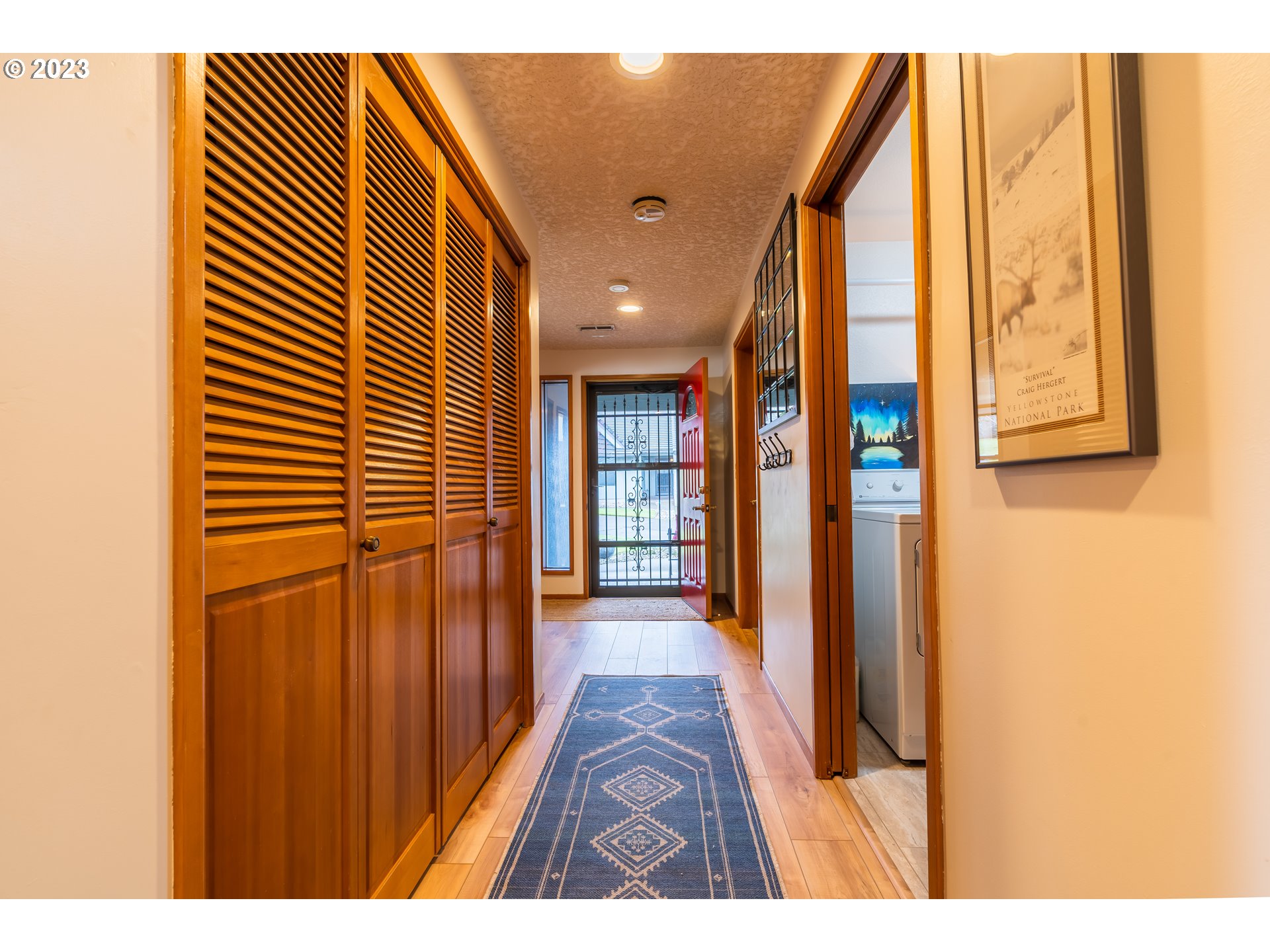 3300 Northeast 164th Street, Unit D1 Ridgefield, WA 98642 - Photo 4 of 27 a view of a hallway with wooden floor and windows