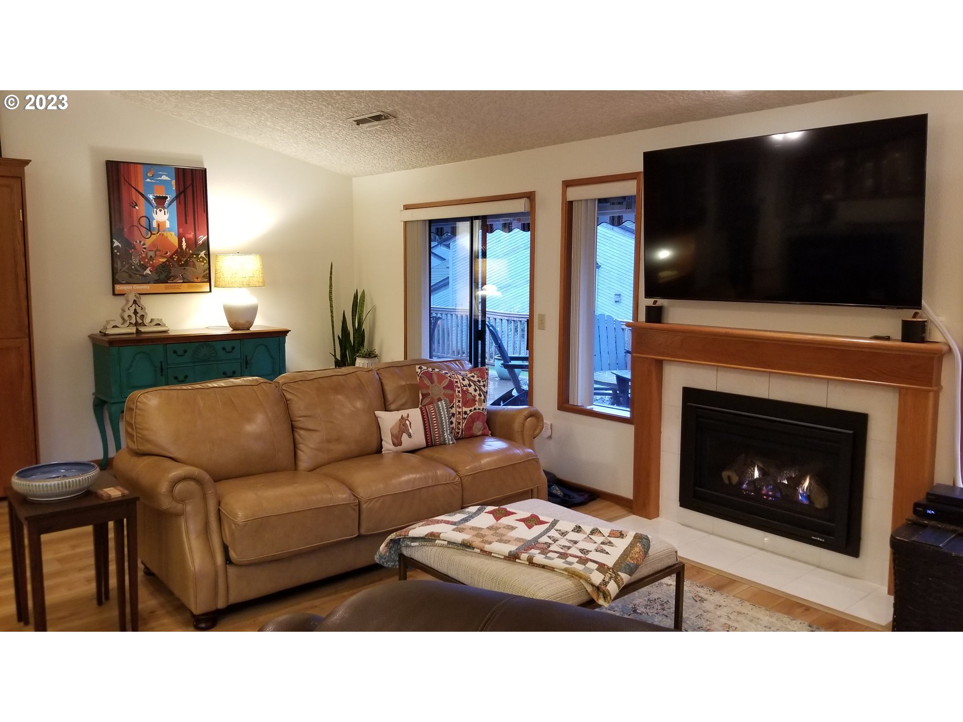 3300 Northeast 164th Street, Unit D1 Ridgefield, WA 98642 - Photo 8 of 27 a living room with furniture a flat screen tv and a fireplace