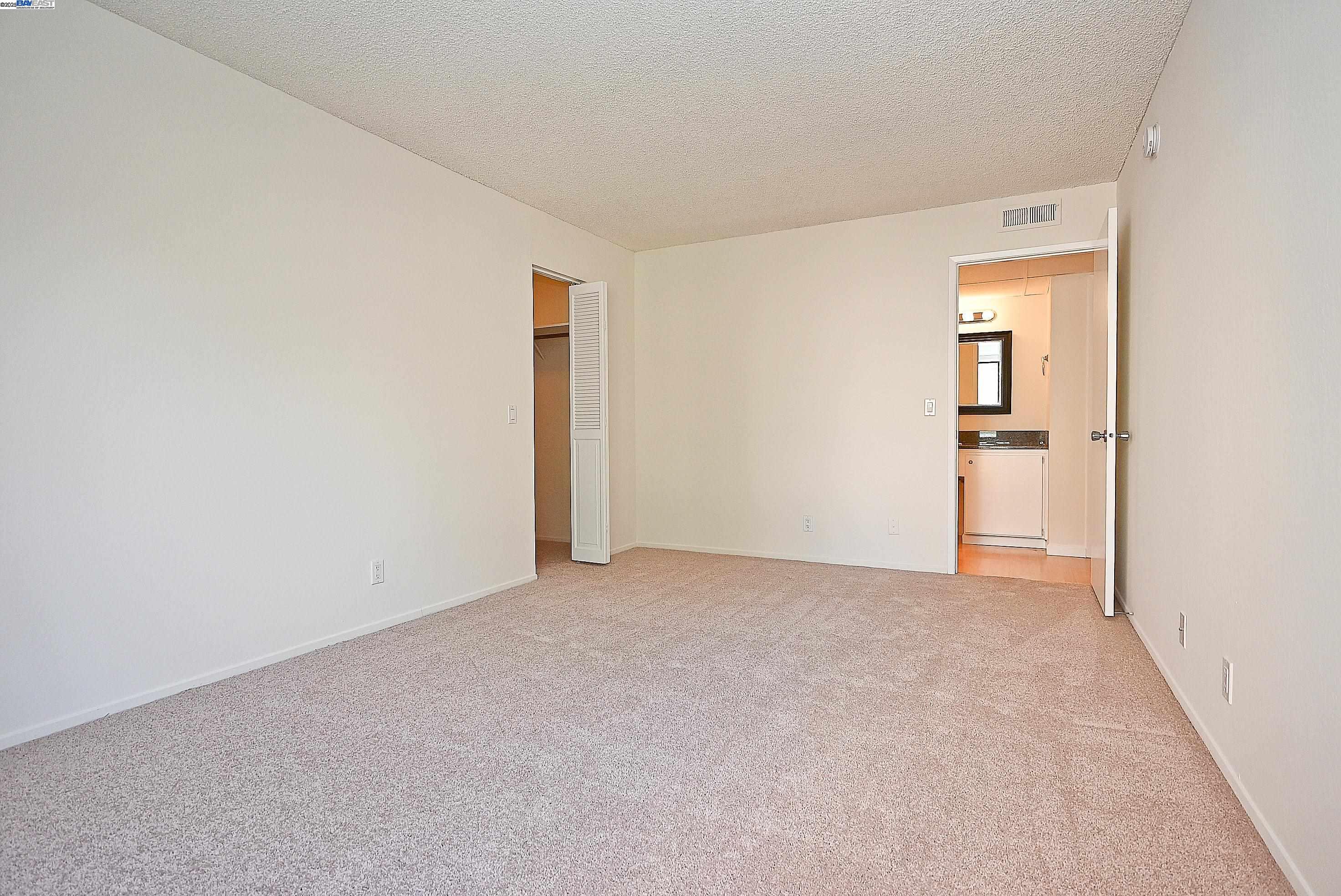 320 North Civic Drive, Unit 307 Walnut Creek, CA 94596 - Photo 18 of 37 an empty room with closet and mirror