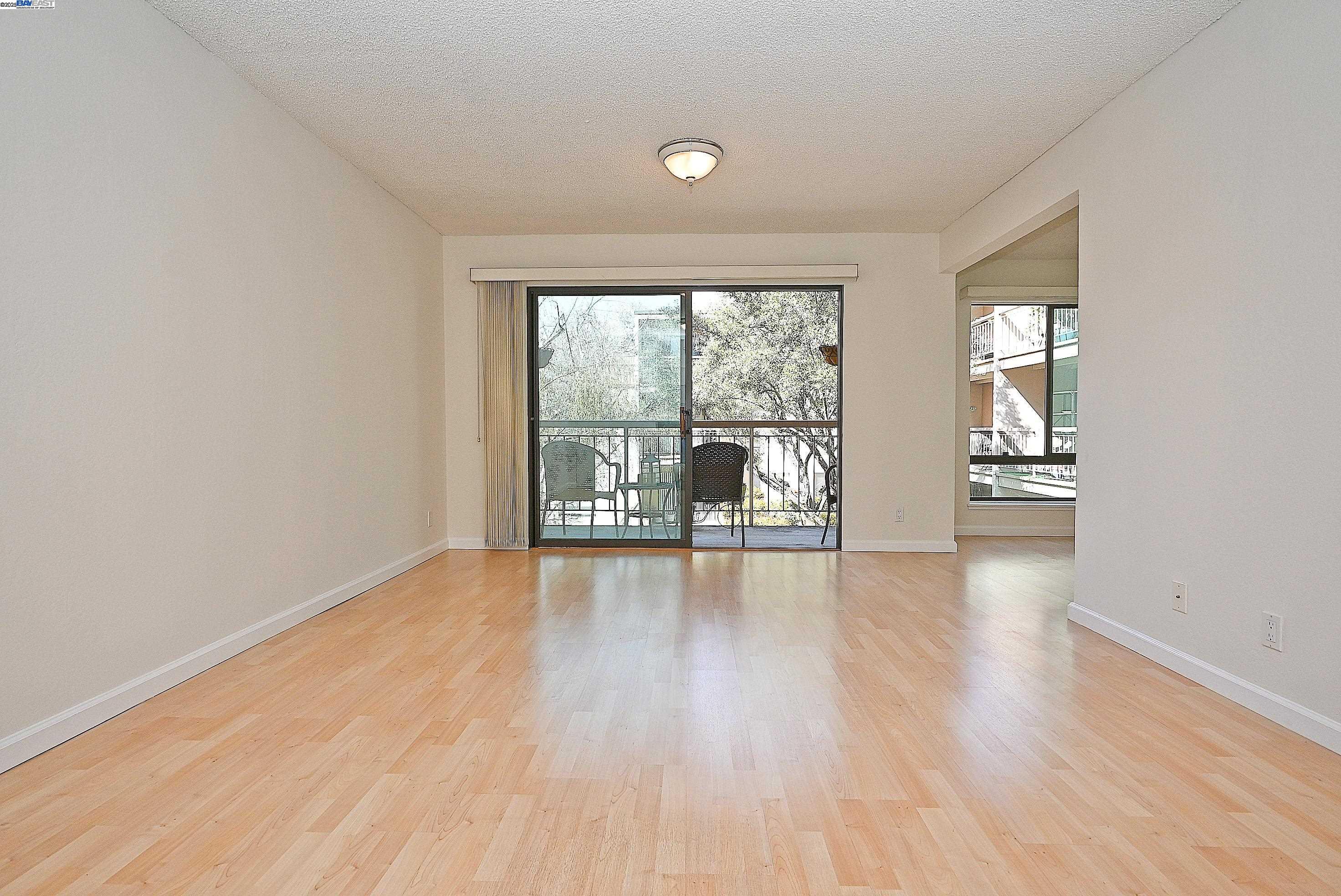 320 North Civic Drive, Unit 307 Walnut Creek, CA 94596 - Photo 3 of 37 an empty room with wooden floor and windows