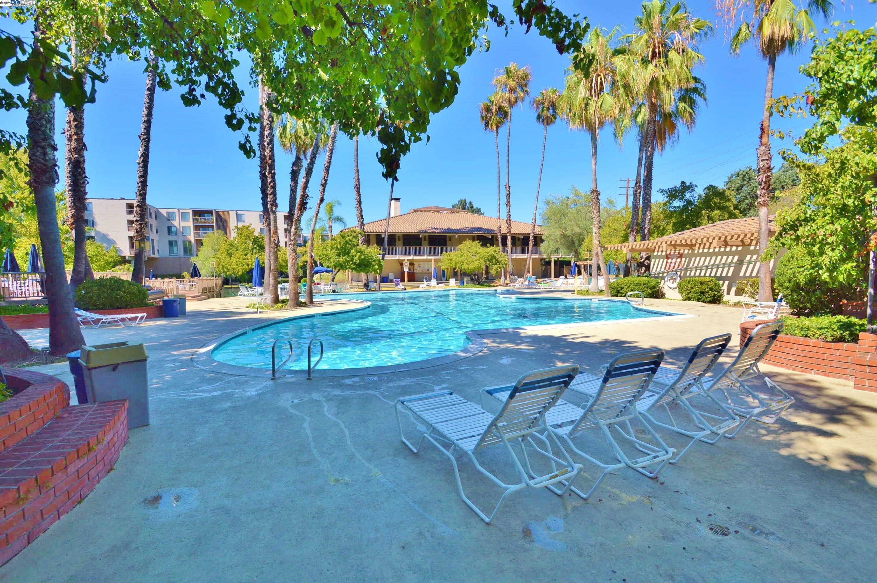 320 North Civic Drive, Unit 307 Walnut Creek, CA 94596 - Photo 33 of 37 a view of a patio with a table and chairs under an umbrella