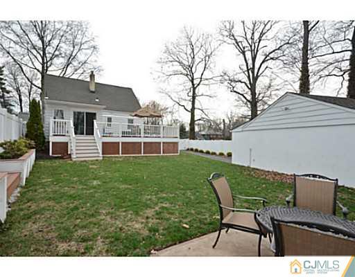 110 Highfield Road Colonia, NJ 07067 - Photo 18 of 23 a view of a house with backyard sitting area and garden