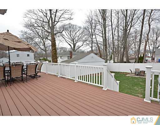 110 Highfield Road Colonia, NJ 07067 - Photo 6 of 23 a view of backyard with a deck and wooden floor