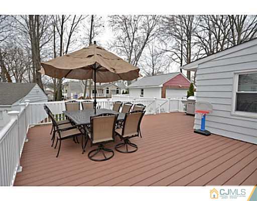 110 Highfield Road Colonia, NJ 07067 - Photo 7 of 23 a view of a roof deck with table and chairs under an umbrella