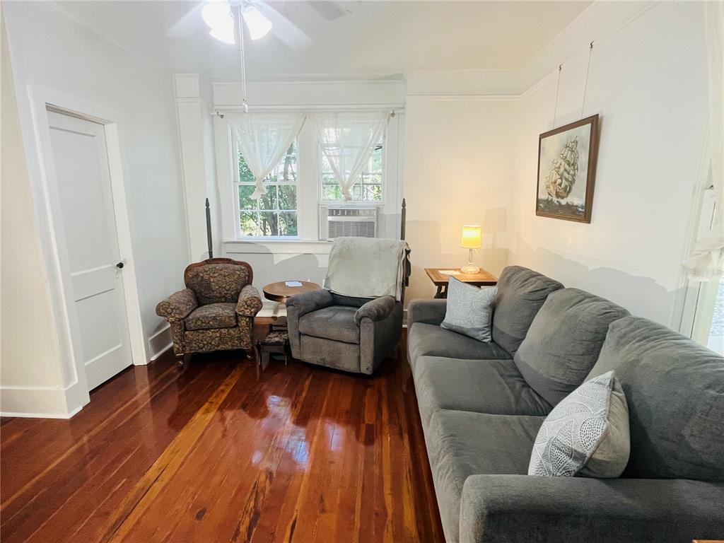 1124 Northwest 4th Street Gainesville, FL 32601 - Photo 15 of 25 a living room with furniture and a wooden floor