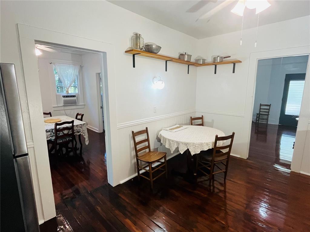 1124 Northwest 4th Street Gainesville, FL 32601 - Photo 17 of 25 a view of a dining room with furniture and wooden floor