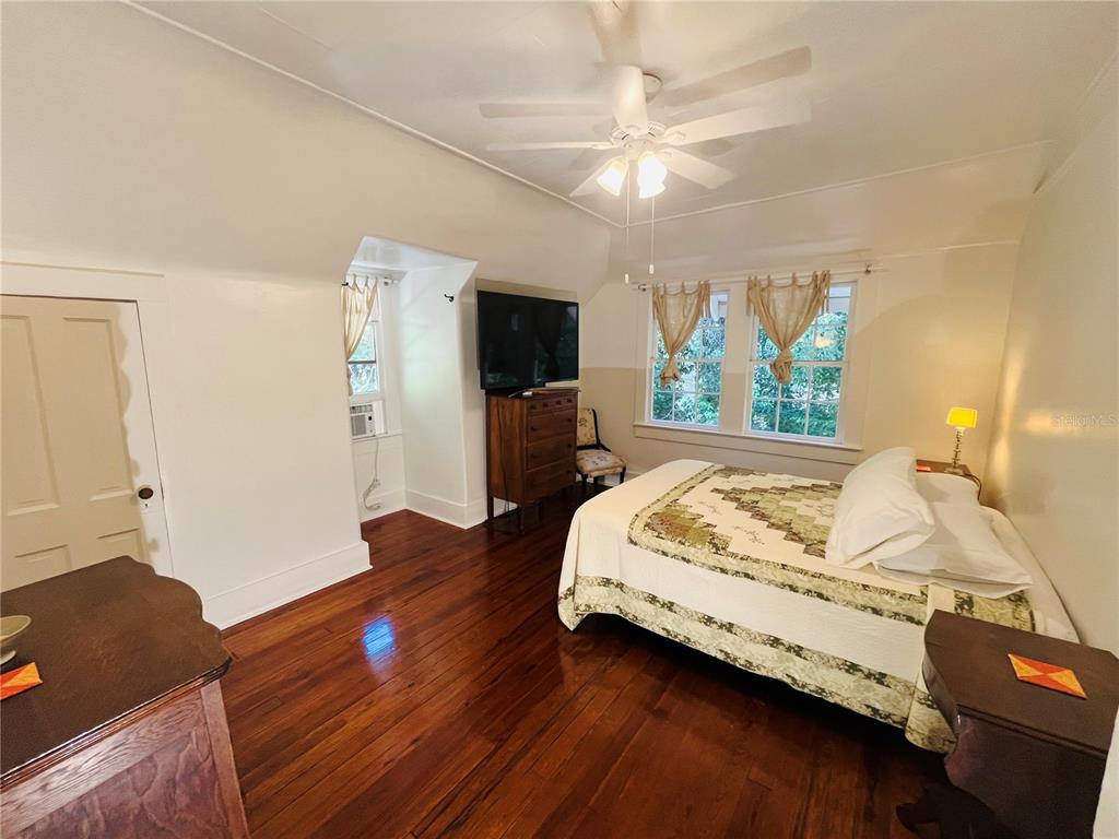 1124 Northwest 4th Street Gainesville, FL 32601 - Photo 9 of 25 a bed sitting in a spacious bedroom next to a window