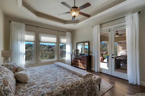 a bedroom with a bed and glass walk in closet