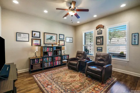 a living room with furniture and a book shelf