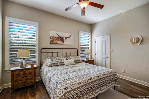 a bedroom with a large bed and a chandelier