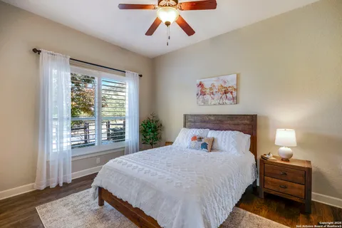 a bedroom with a large bed and a large window
