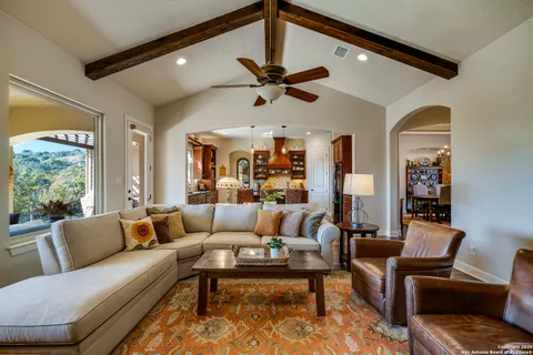 a living room with furniture ceiling fan and a rug