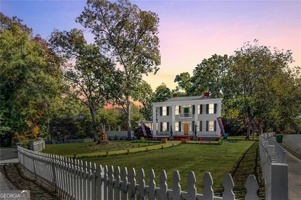 a view of a house with a yard from a chairs