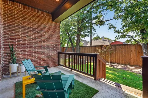 a view of a backyard with couches with wooden fence
