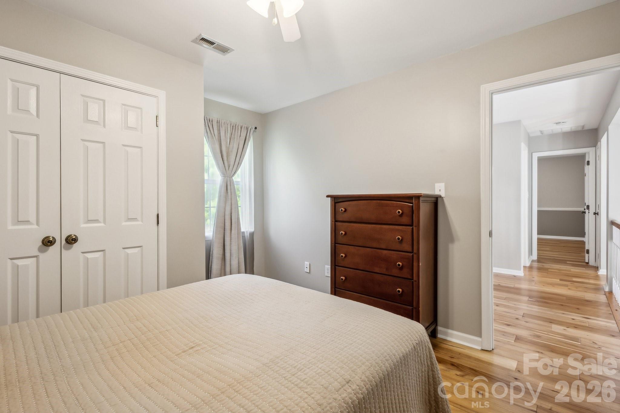 3223 Rheinwood Court Matthews, NC 28105 - Photo 11 of 16 a bedroom with a bed and a dresser