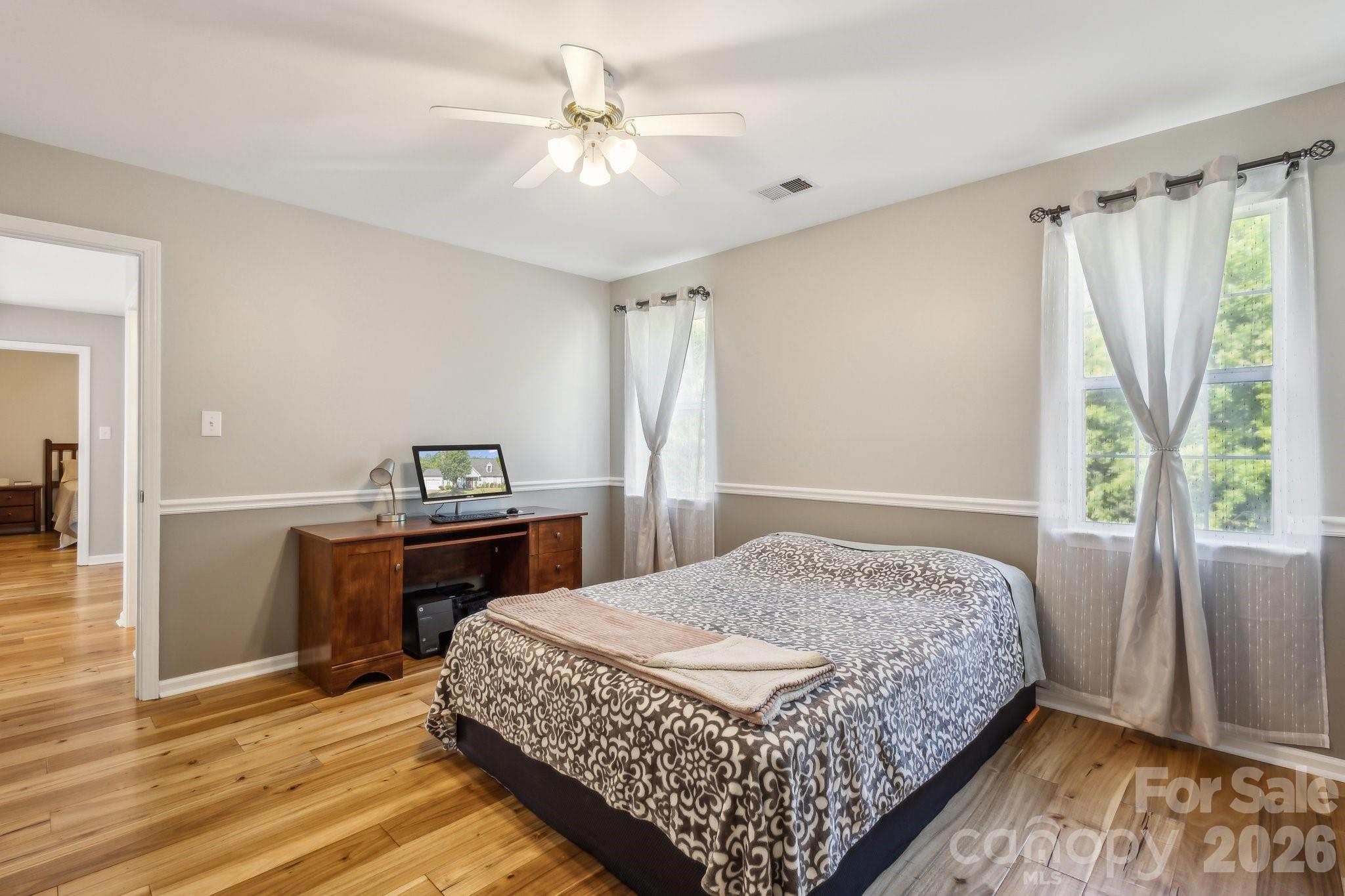 3223 Rheinwood Court Matthews, NC 28105 - Photo 13 of 16 a bedroom with a bed and a chandelier