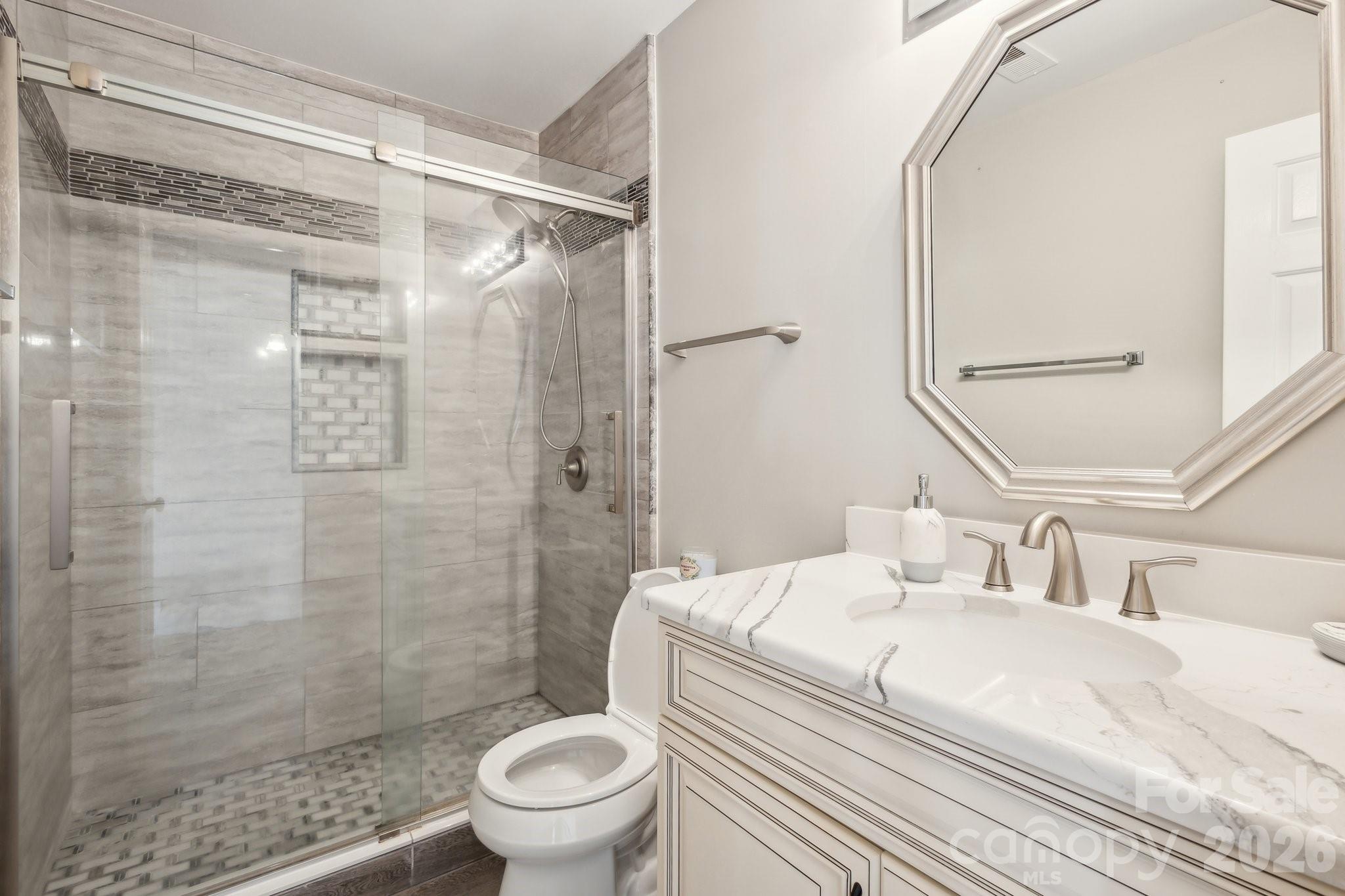 3223 Rheinwood Court Matthews, NC 28105 - Photo 14 of 16 a bathroom with a sink toilet and shower