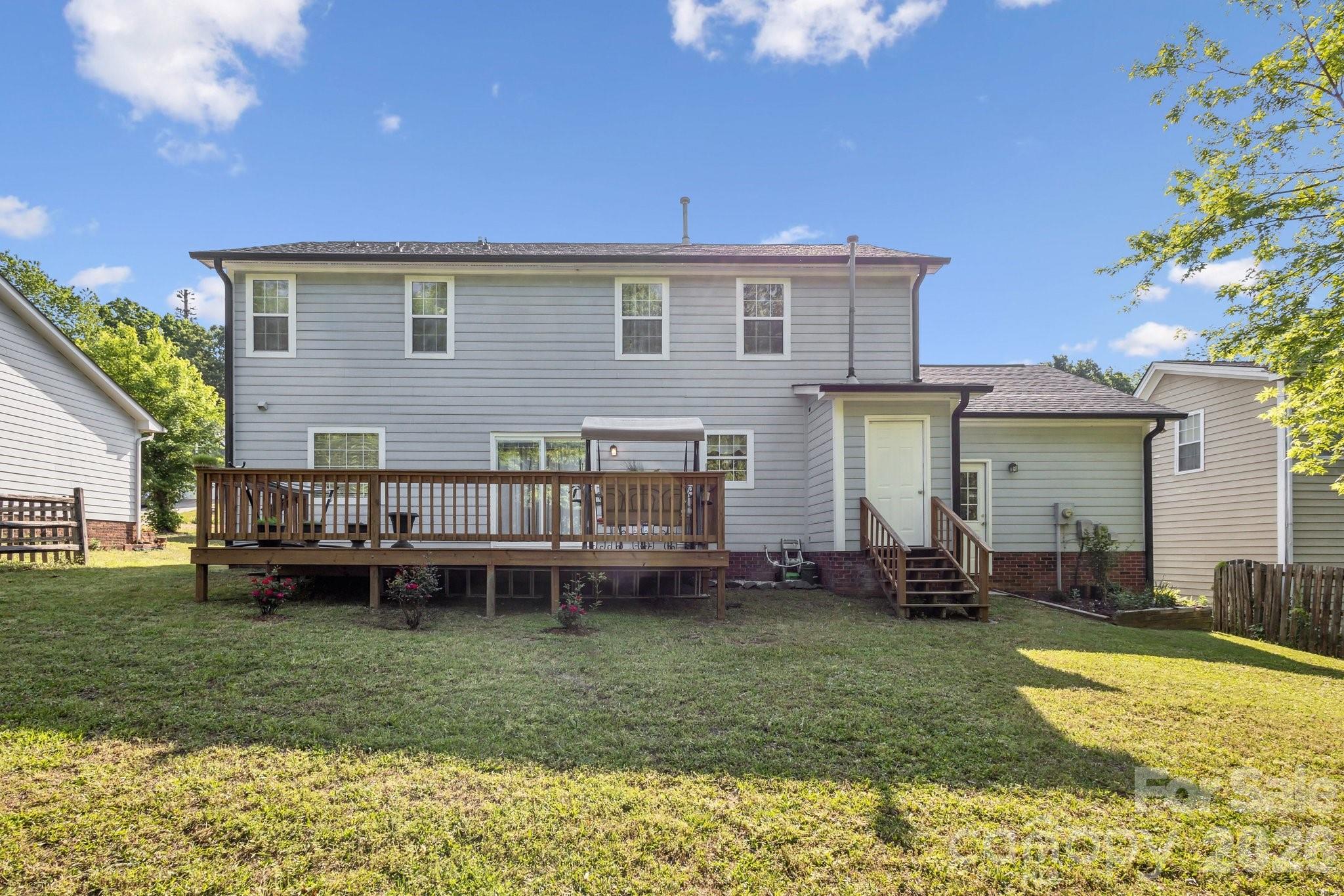 3223 Rheinwood Court Matthews, NC 28105 - Photo 15 of 16 a view of a house with a backyard and a patio