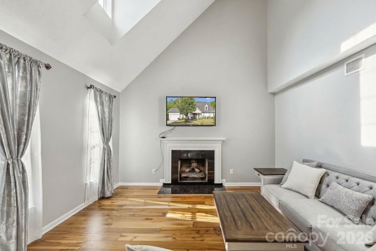 3223 Rheinwood Court Matthews, NC 28105 - Photo 2 of 16 a living room with furniture and a fireplace