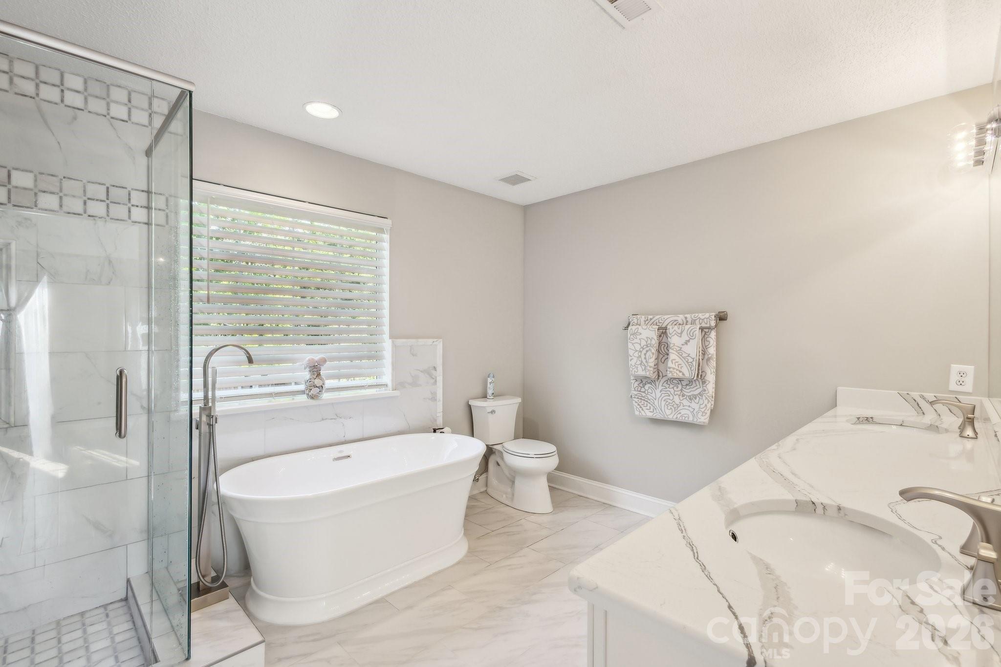 3223 Rheinwood Court Matthews, NC 28105 - Photo 5 of 16 a spacious bedroom with a bed and glass window