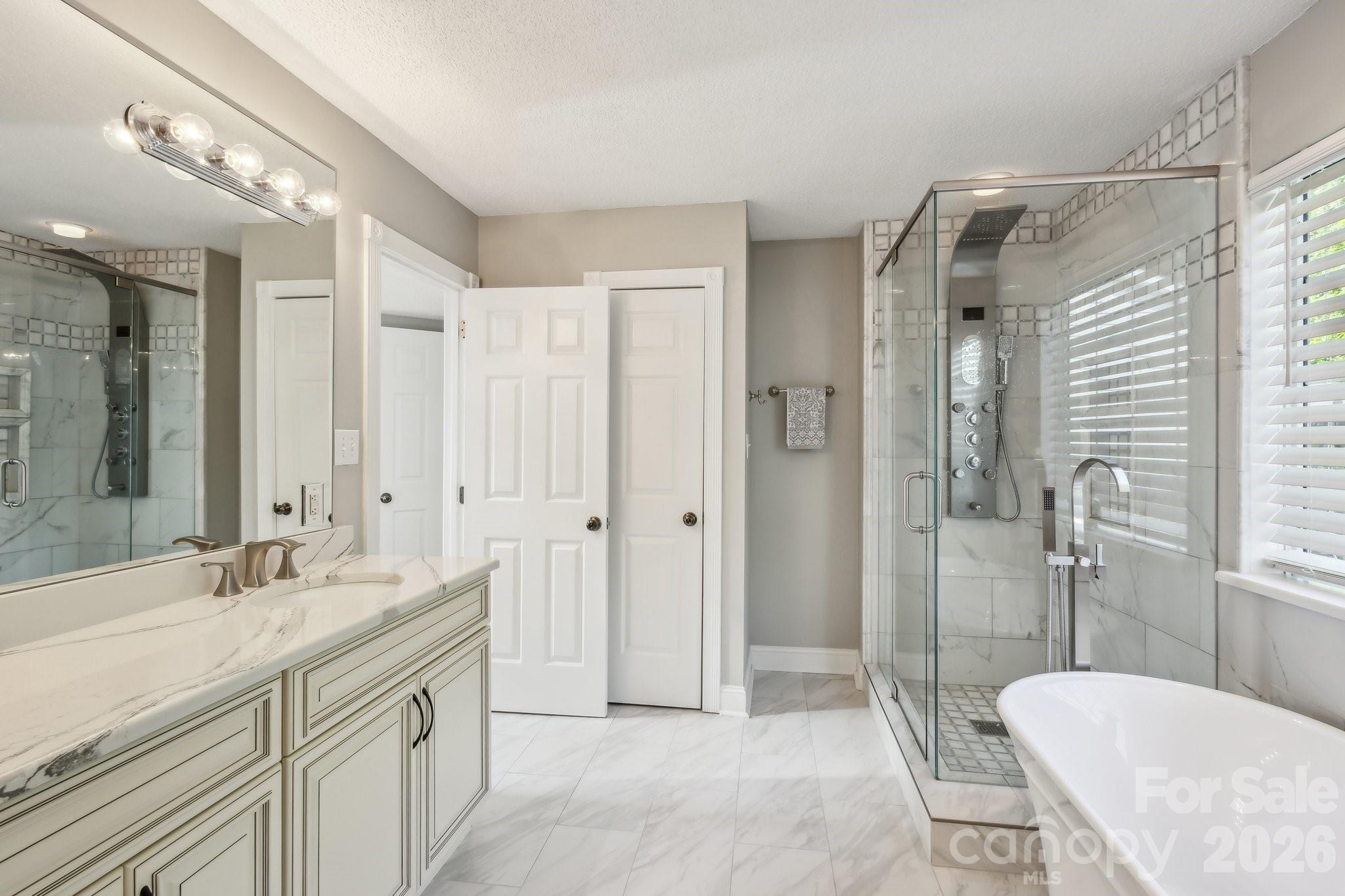 3223 Rheinwood Court Matthews, NC 28105 - Photo 6 of 16 a spacious bathroom with a shower sink and mirror