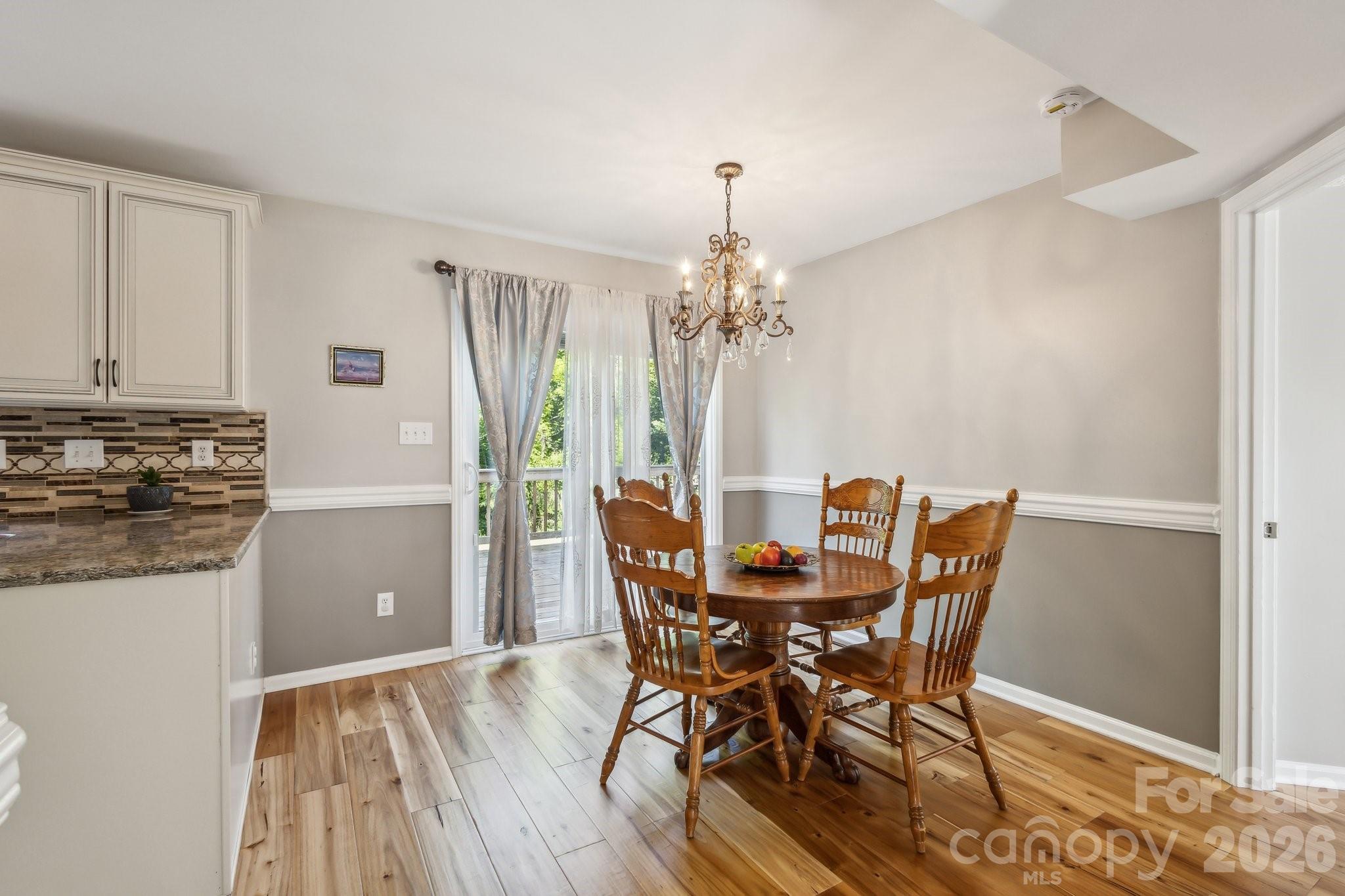 3223 Rheinwood Court Matthews, NC 28105 - Photo 8 of 16 a view of a dining room with furniture and chandelier