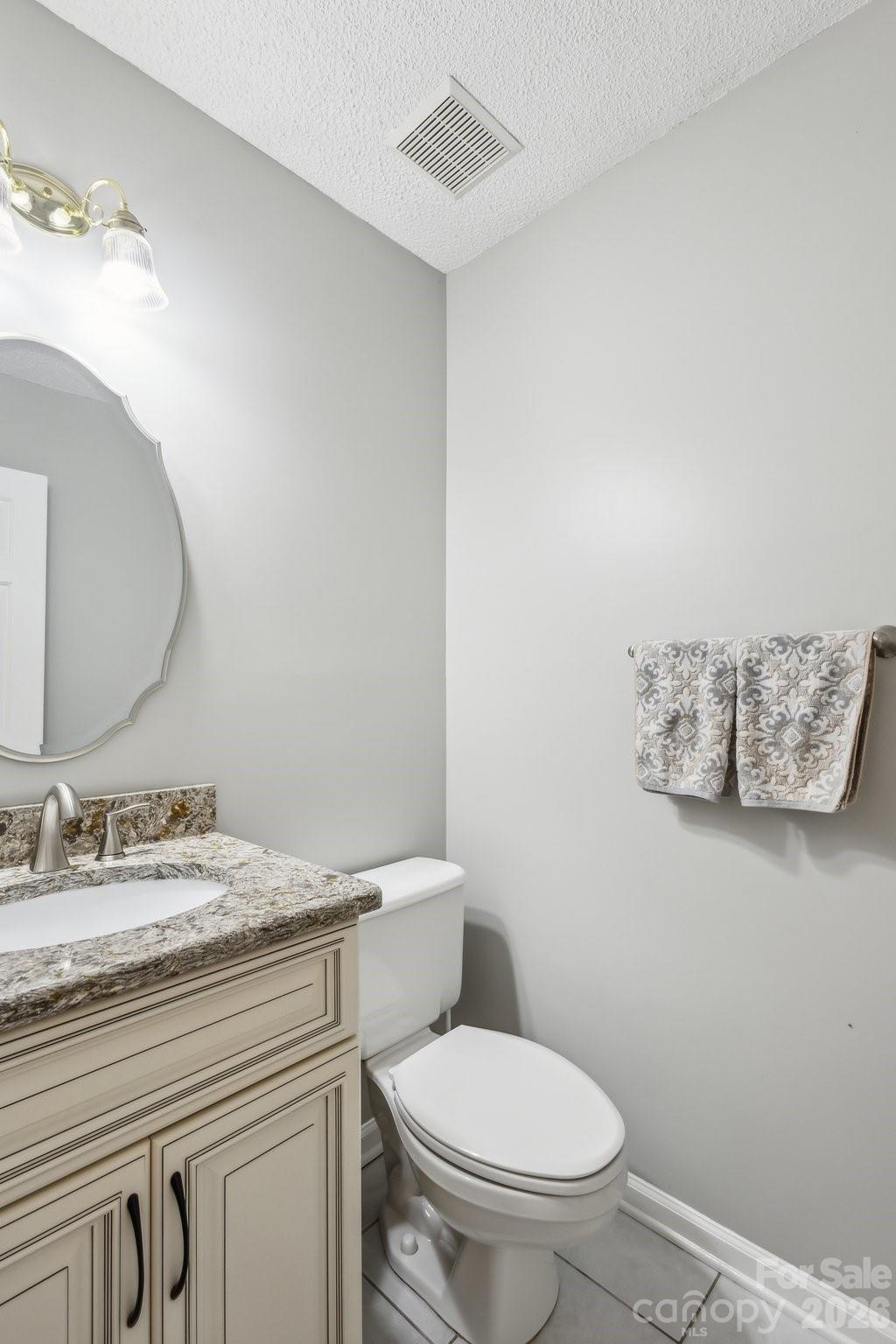 3223 Rheinwood Court Matthews, NC 28105 - Photo 9 of 16 a bathroom with a granite countertop toilet sink and mirror