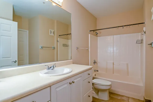 a bathroom with a sink toilet a mirror and shower