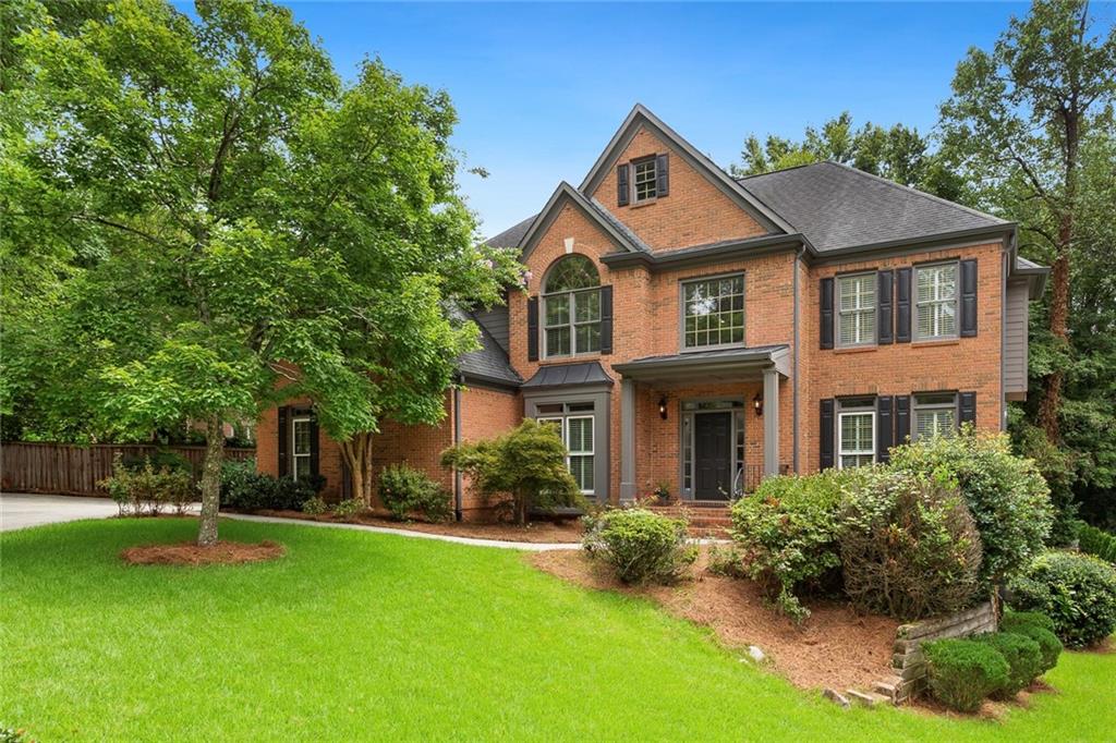 1151 Goodwin Road Northeast Atlanta, GA 30324 - Photo 1 of 1 a front view of a house with a yard