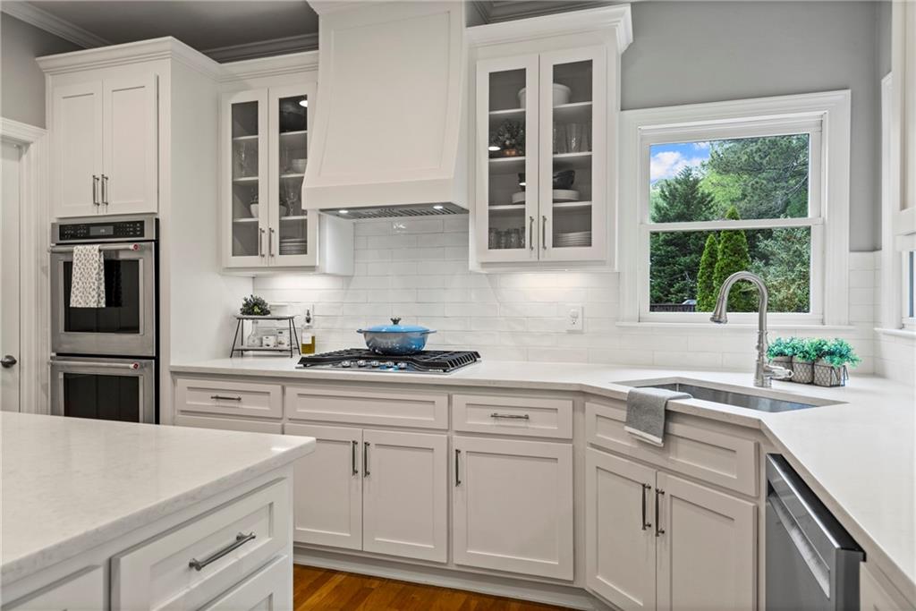 a kitchen with stainless steel appliances white cabinets and a sink