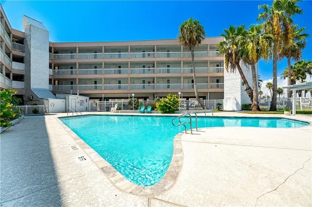 a view of a swimming pool with sitting area