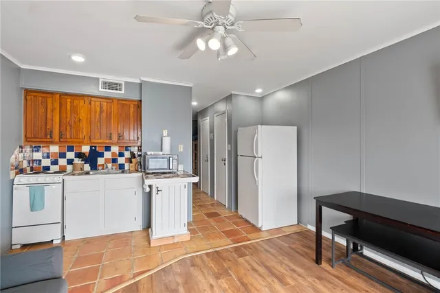 a view of a kitchen with wooden floor and a kitchen