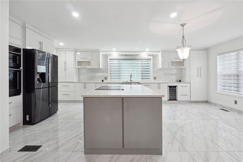 3149 Lakeview Parkway Villa Rica, GA 30180 - Photo 12 of 29 a kitchen with kitchen island a counter top space stainless steel appliances and a window