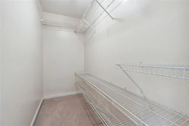 a bathroom with a sink toilet and large mirror