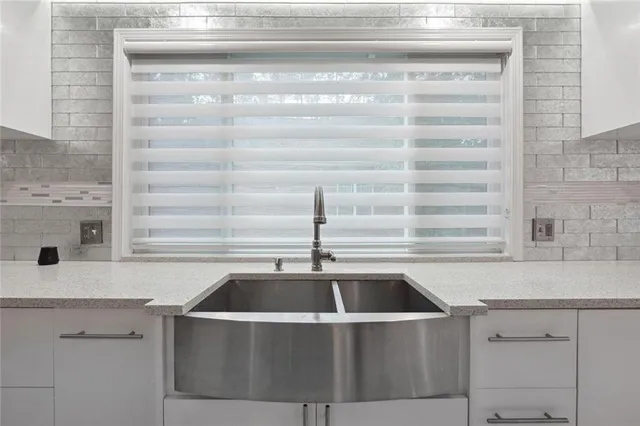 a kitchen with a sink and cabinets