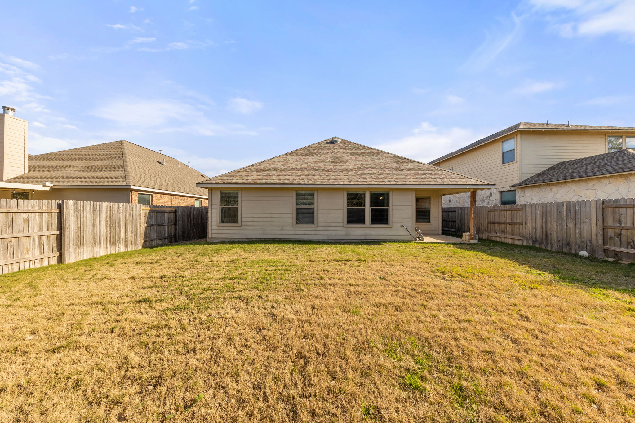 411 Tascate Street Georgetown, TX 78628 - Photo 36 of 41 A spacious backyard with mature fencing offers ample outdoor living potential.