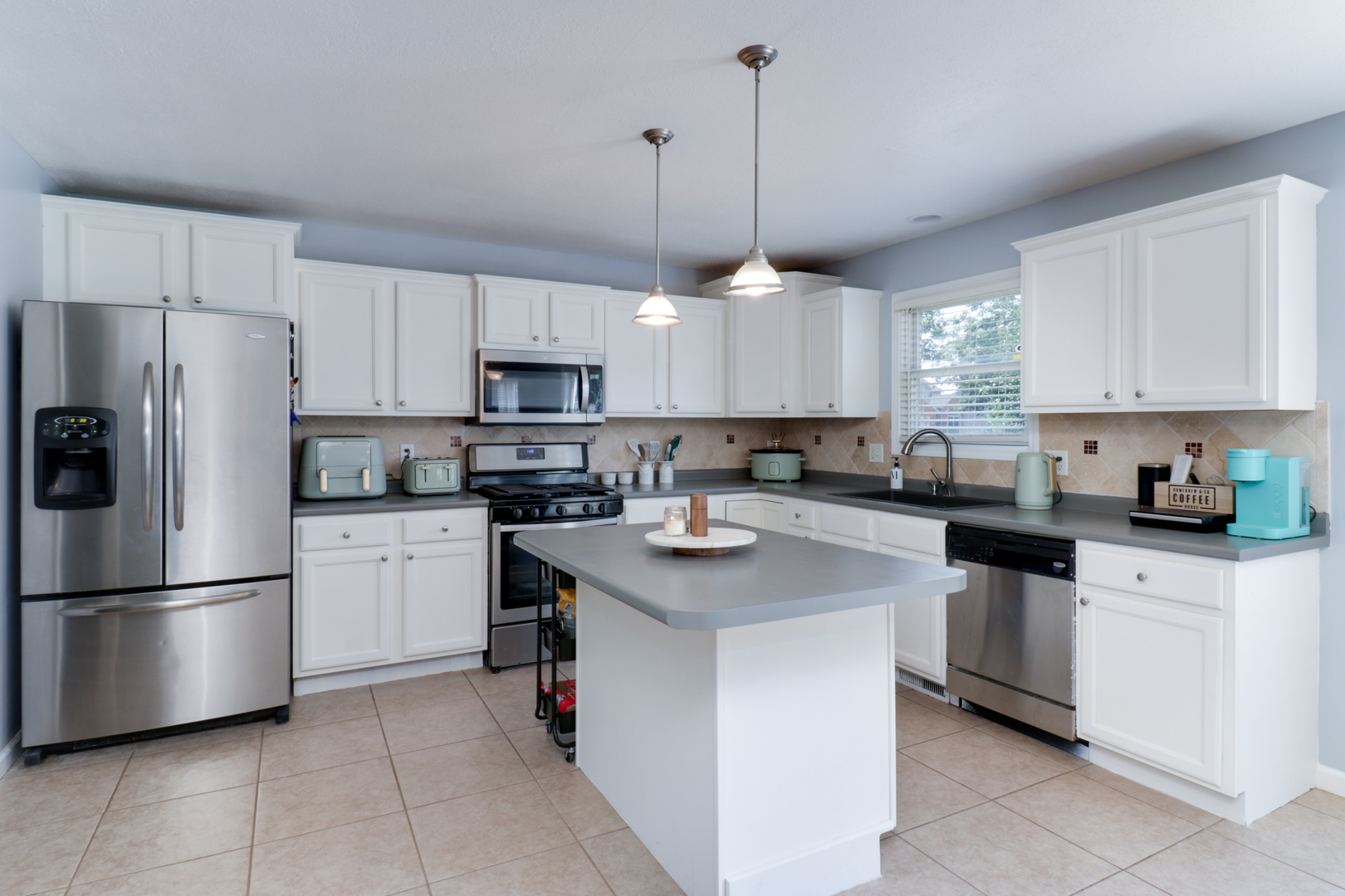 3283 Marimarsh Lane Normal, IL 61761 - Photo 3 of 28 a kitchen with stainless steel appliances granite countertop a refrigerator a sink a stove a microwave and a refrigerator