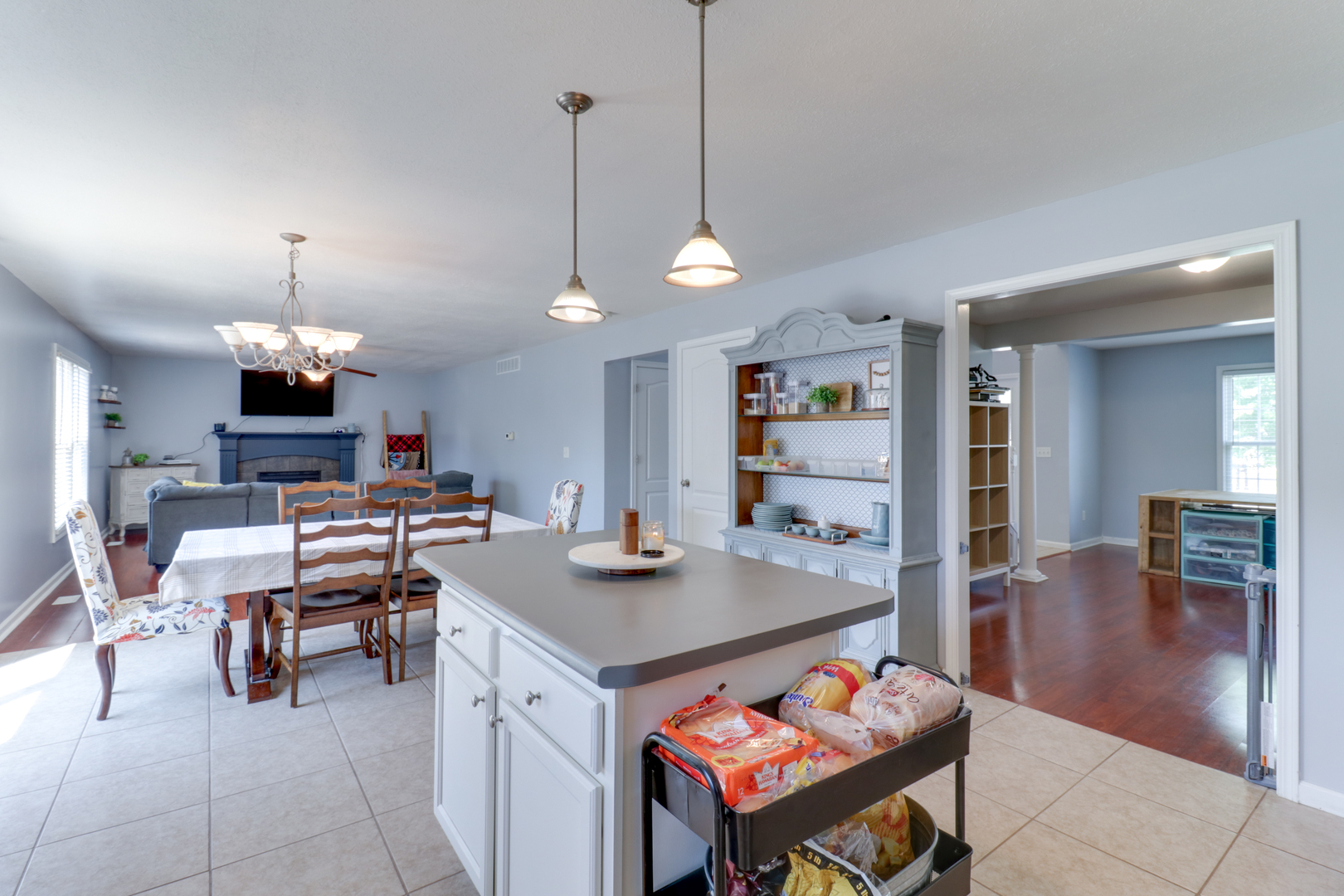 3283 Marimarsh Lane Normal, IL 61761 - Photo 6 of 28 a view of a dining room and livingroom furniture wooden floor a rug and a chandelier