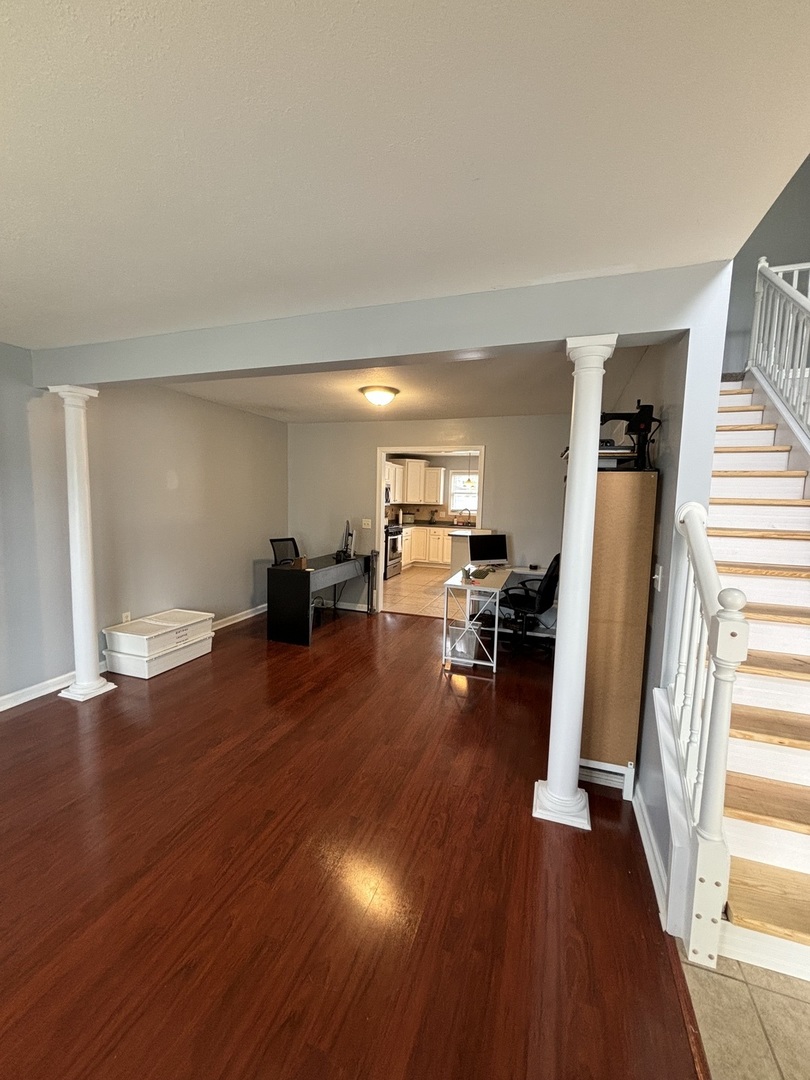 3283 Marimarsh Lane Normal, IL 61761 - Photo 10 of 28 a living room with furniture and a wooden floor
