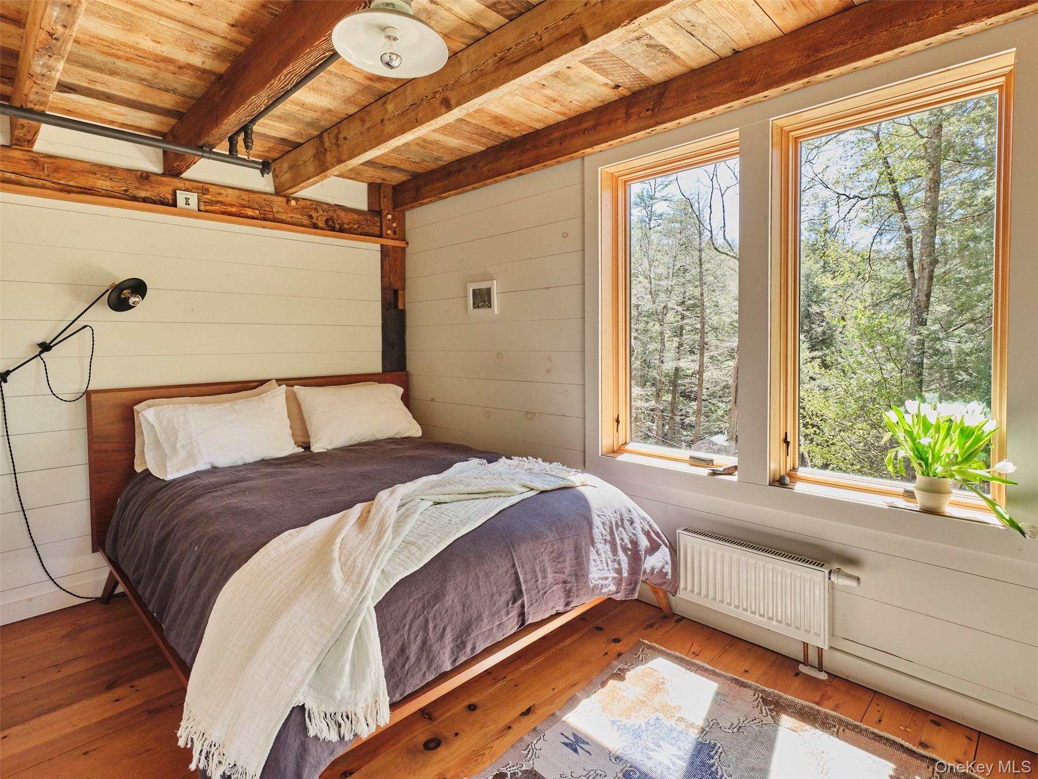 55 Woods Road Barryville, NY 12719 - Photo 32 of 50 a bedroom with a bed and a large window