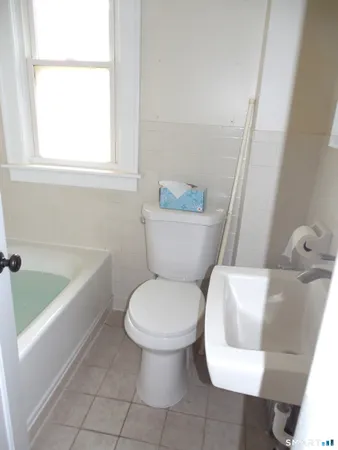a bathroom with a toilet and a bathtub