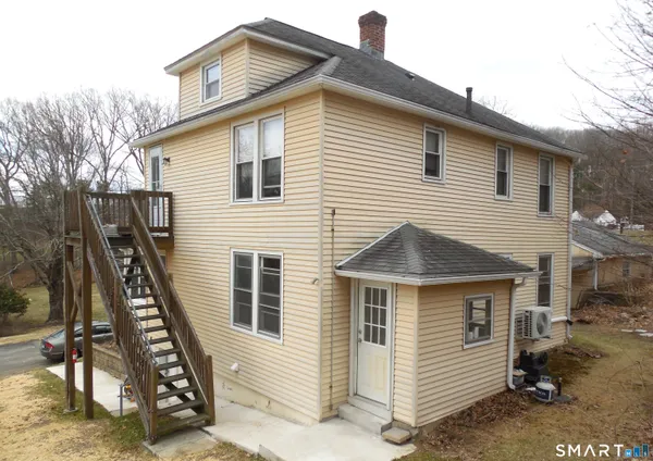 a view of a house with a wooden fence