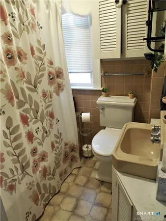 a white toilet sitting next to a bathroom sink