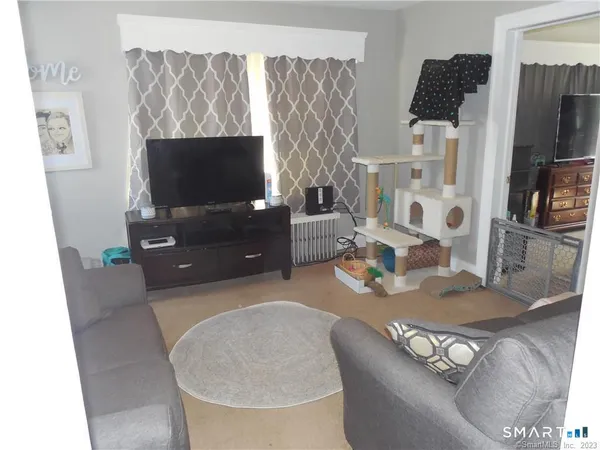 a living room with furniture and a flat screen tv