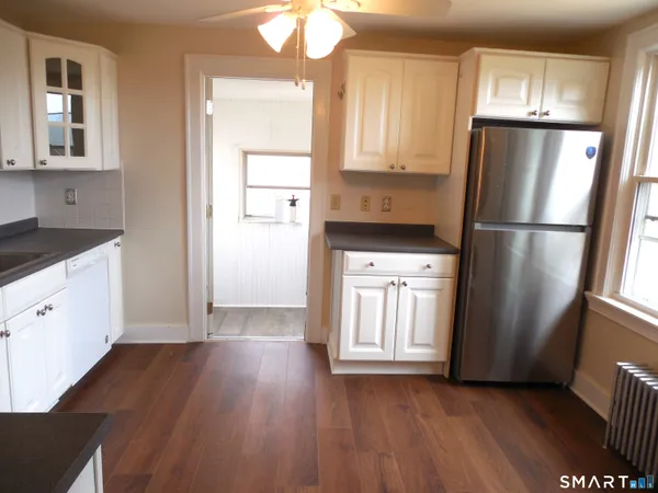 a kitchen with a refrigerator a sink and cabinets